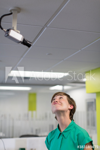 Silly businesswoman making face at surveillance camera