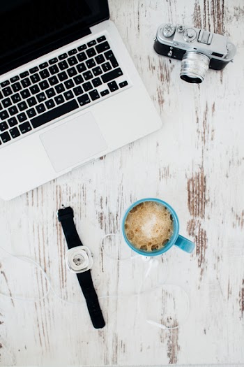 Silver and Black Camera; Silver and Black Laptop; Blue Ceramic Mug