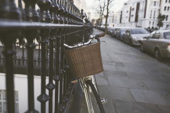 Silver Bicycle on Black Steel Fence
