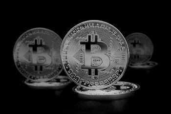 Silver Bitcoin Coins on Black Background