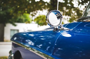 silver car side mirror in shallow focus photography