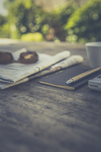 Silver Click Pen on Brown Wooden Table during Daytime