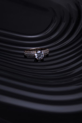 Silver-colored Ring on Black Panel
