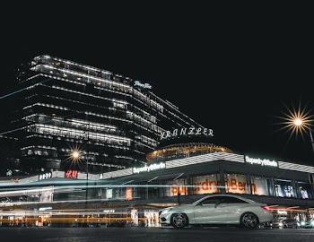 silver coupe parked near Xranzier building during night time