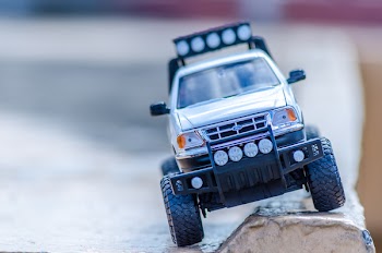 Silver Ford Toy Car on the Ground
