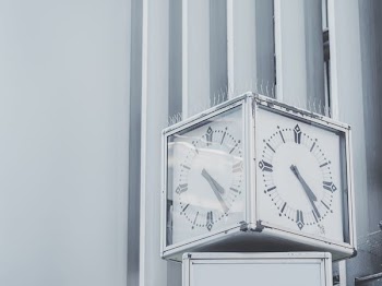 silver framed clock at 4:25
