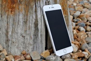 Silver Iphone 6 on Gray and Brown Stone