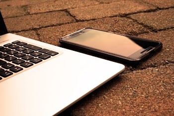 Silver Laptop Computer Beside Black Android Smartphone Turned Off