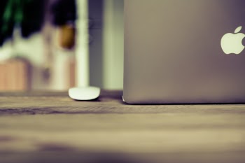 Silver Macbook on Brown Wooden Surface