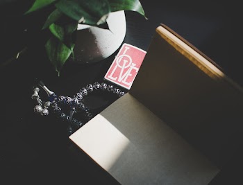 Silver Misbaha Prayer Beads Beside Book and Plant
