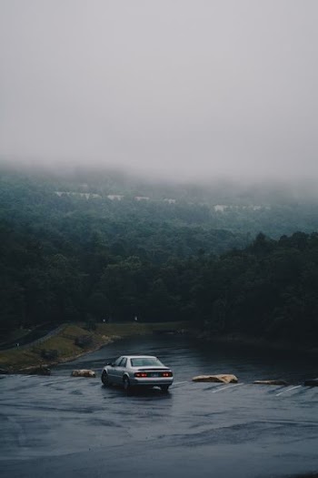 silver sedan on road
