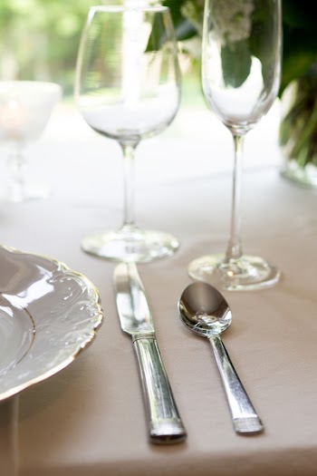 Silver Spoon and Knife on Table Near White Plate