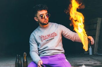 Sitting Man Holding Lit Molotov Cocktail