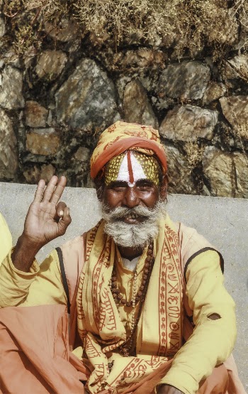 Sitting Man Holding Out Okay Hand Sign