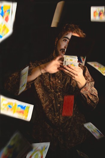Sitting Man Throwing Cards