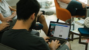 Sitting Man Using Laptop Inside A Room