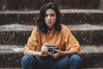 Sitting Woman Holding Gray Point-and-shoot Camera