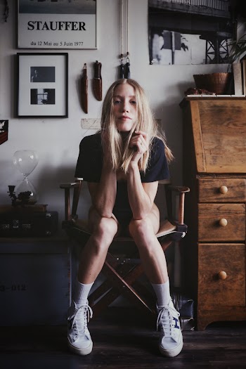 Sitting Woman on a Chair Resting Arms on Knees