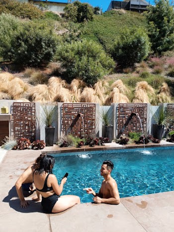 Sitting Woman Wearing Black Bikini Beside Pool