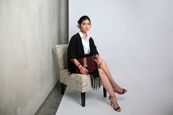 Sitting Woman Wearing Black Blazer Near Wall