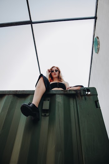 Sitting Woman Wearing Black Shorts