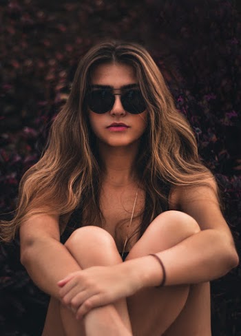 Sitting Woman Wearing Black Sunglasses