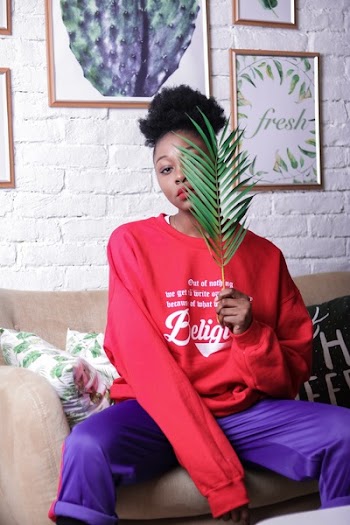 Sitting Woman Wearing Red Sweater And Purple Pants