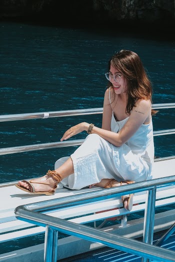 Sitting Woman Wearing White Spaghetti Strap Dress