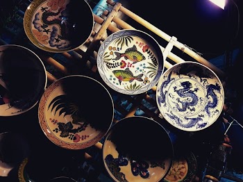 Six Toile Plates On Wooden Surface
