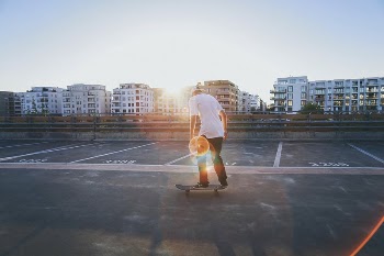 Skateboarder rides his board on a rooftop. | Free Photo - rawpixel