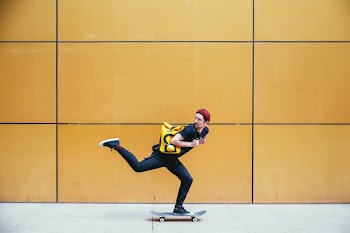 Skateboarder Rides Past