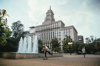 Skateboarding Past Fountain