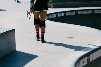 Skater Leaves The Bowl At Outdoor Skate Park