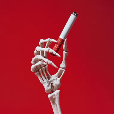 Skeleton Hand Pulling Cigarette Against Red Background in Product Style