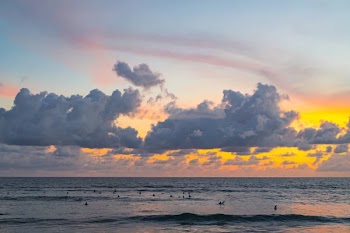 Sky and ocean beautiful sunset on the ocean. surfers waiting for a wave.