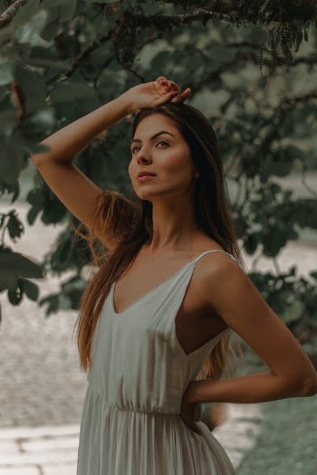 Slender woman in summer cotton dress near green tree · Free Stock Photo