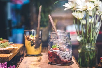 Slice Fruit in Clear Glass Jar Above Brown Wooden Table