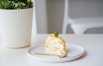 Slice of Fruit Cake in White Saucer