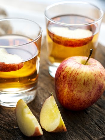 Sliced Apple Beside Two Apple Juice
