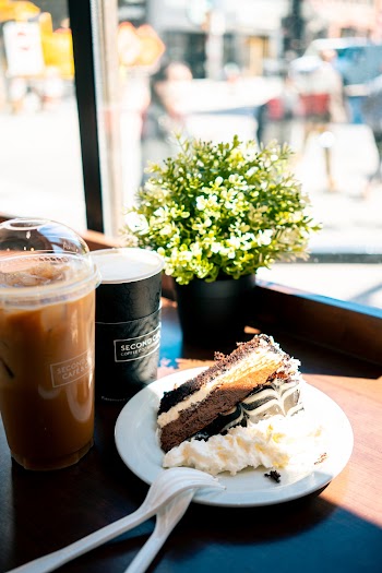 Sliced Chocolate Cake On Saucer With Drinks on Table