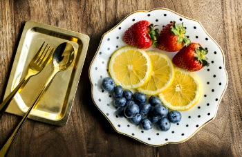 Sliced Lemon Fruit With Strawberry and Blueberry in White Ceramic Plate