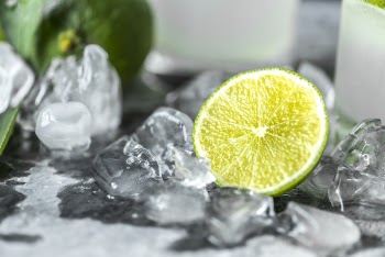 Sliced Lime Beside Melted Ice