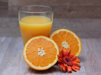 Sliced Orange Fruit and Orange Juice in glass