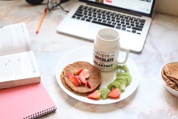 Sliced Strawberries And Kiwi On Plate Near Macbook