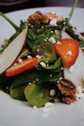 Sliced Strawberry And Green Leaf Vegetables On White Ceramic Plate