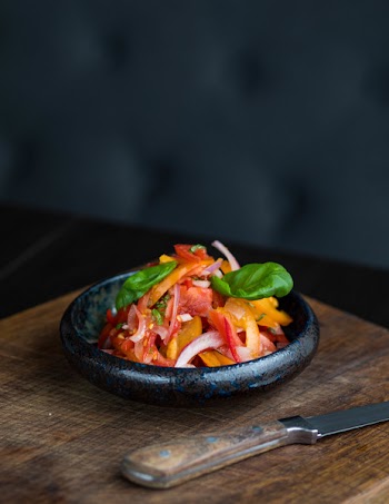Sliced Tomato With Green Vegetables in Brown Saucer