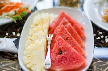 Sliced Watermelon and Pineapple Fruit With Stainless Steel Fork Placed on White Ceramic Rectangular Plate