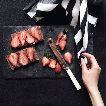 Slices Strawberries on Chopping Board