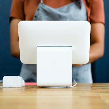 Small business owner at a cash register | Free stock photo | High Resolution image