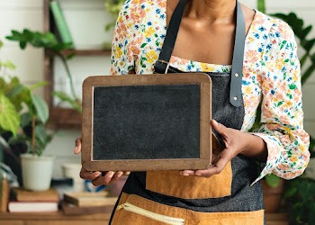Small business owner holding a blank sign  | Free stock photo | High Resolution image